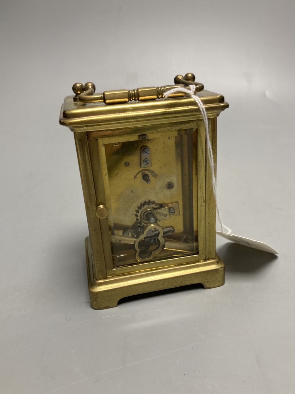 A gilt-brass carriage timepiece, with white enamelled Roman dial and outer travelling case and another carriage clock (2)